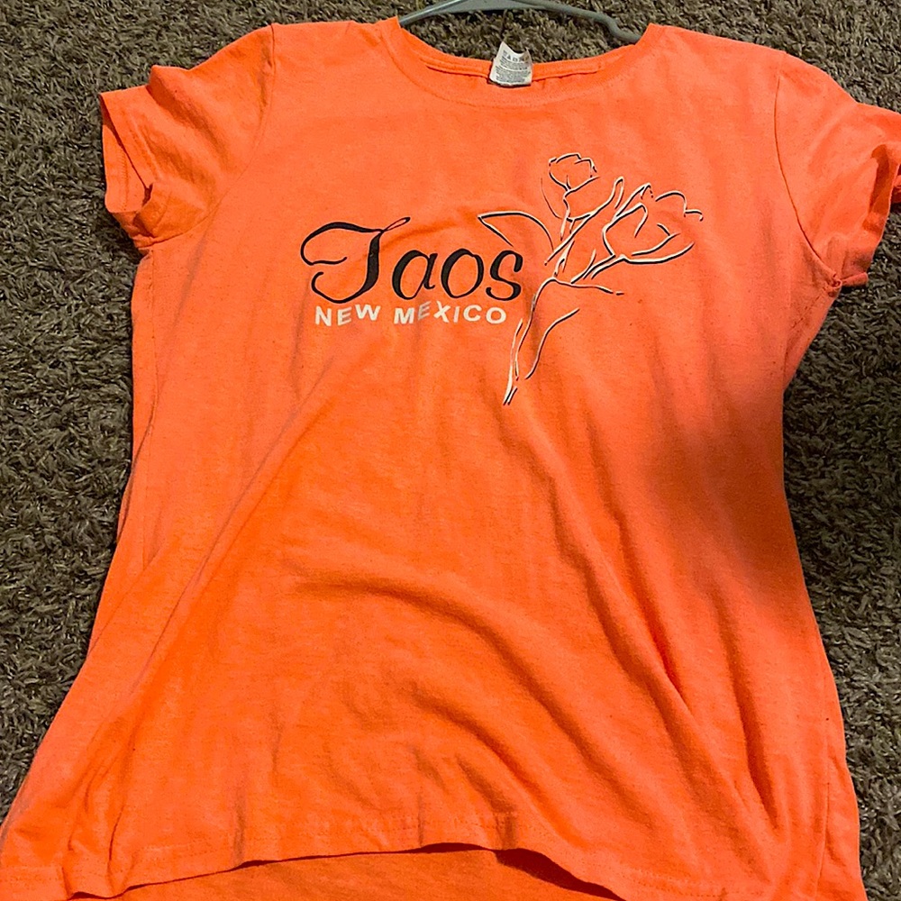 This is a peach color Taos NM shirt size medium for adults